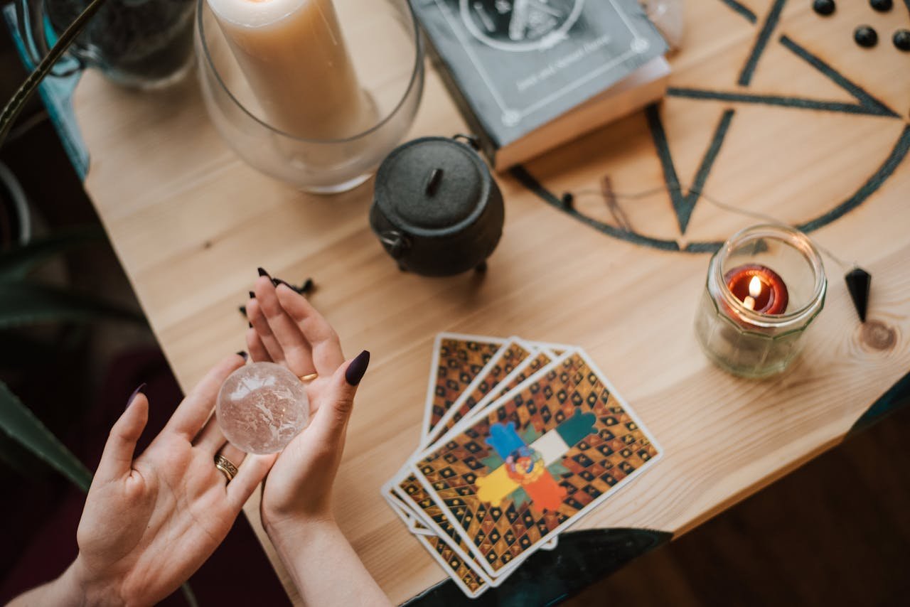 A serene mystical scene with tarot cards, crystals, and candles, perfect for divination.